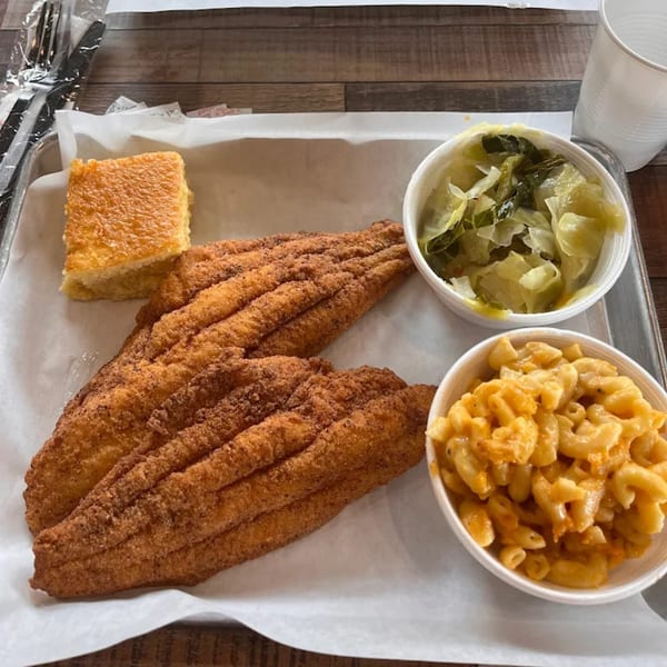 Soul Goode's fried catfish, macaroni and cheese, collard greens, and cornbread on a tray.