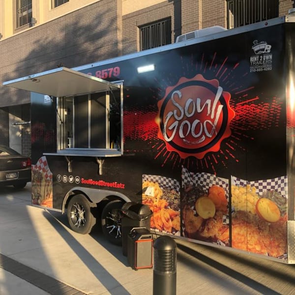 Soul Goode food truck with its serving window open, parked on a sunny street.