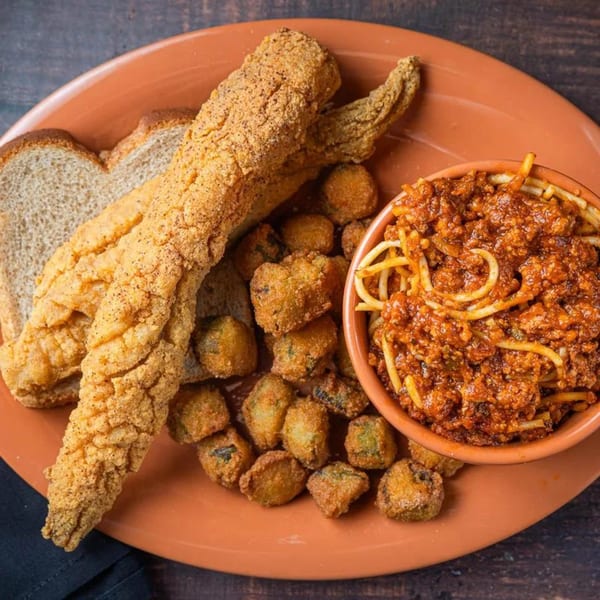 Soul Goode's fried catfish, fried okra, and spaghetti with meat sauce on an orange plate.